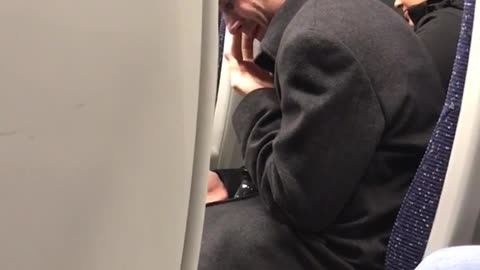 Man black sweater picking nose on train secretly