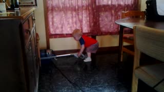 Toddler Bodhi vacuums the cottage to help out.