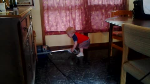 Toddler Bodhi vacuums the cottage to help out.