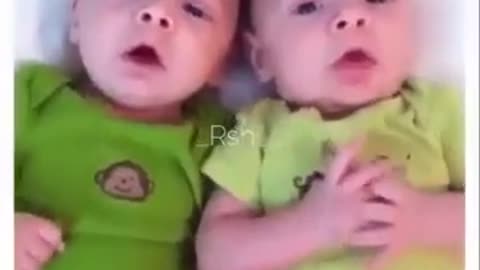 Cute twins sneezes at same time