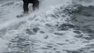 Guy water skiing in a suit