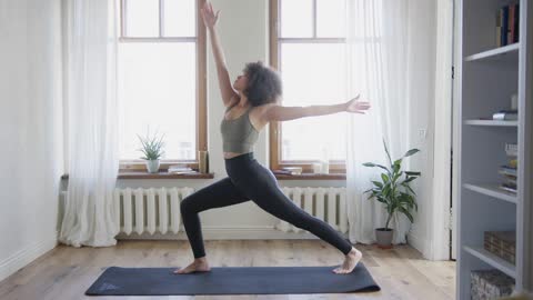 A Woman Doing Stretch Exercises At Home