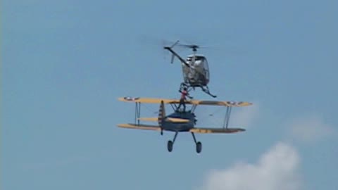 Otto the Helicopter, dare devil jumps from airplane to helicopter in Mid Air at Air Show.