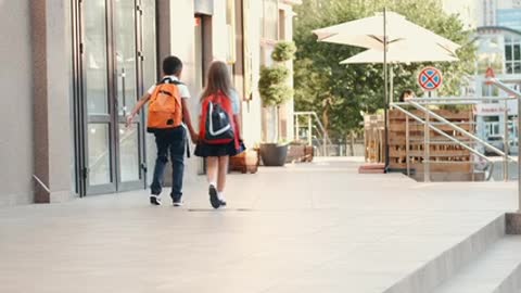 Little Boy And Girl Holding Hands While Walking