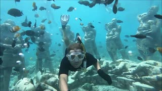 Couple Snorkel Together Through Famous Underwater Statues