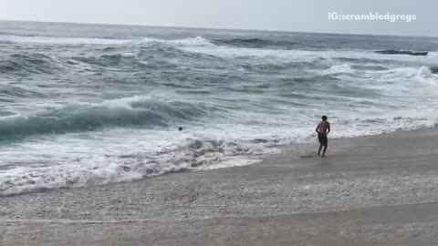 Kids trying to dodge waves get knocked over by waves