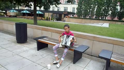 Girl Playing music in Warsaw Streets
