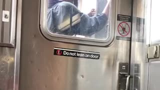 Guy wearing goggles face mask in between subway trains