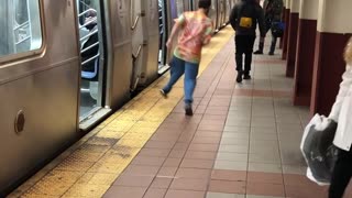 Man colorful shirt jumps out of subway train