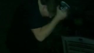 Guy black shirt trying to open beer with head