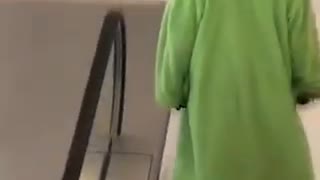 Green wizard walks down stairs