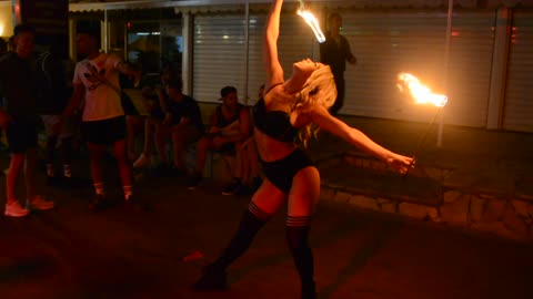 Beautiful woman performs impressive fire act