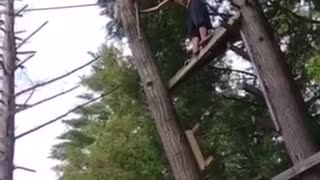 Shirtless man black shorts rope swing back flip