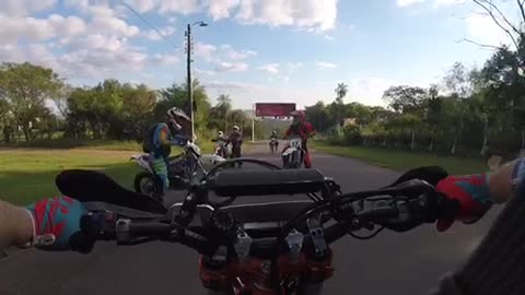 Helmet camera, biker falls back after doing a wheelie on the street