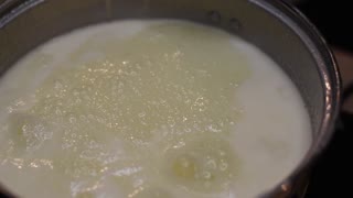 Milk and sugar boiling to a foam in slow motion