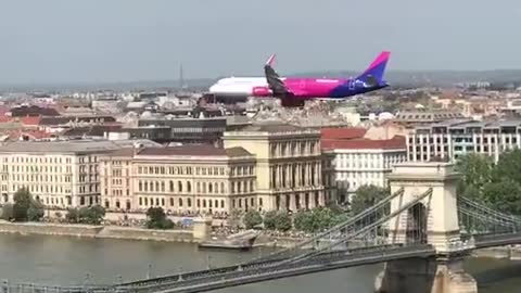 Commercial Plane Flying Low Over Danube River