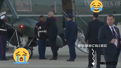Donald Trump puts the police cap on the guard and it falls off.