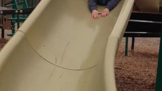 Baby going down the slide for the very first time