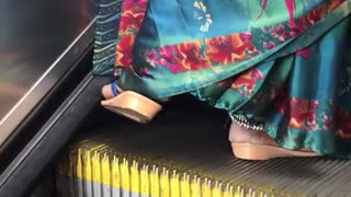 Floral dress sandals dragging food on escalator brushing