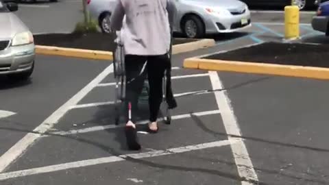 Guy coming out of grocery store with black wet suit