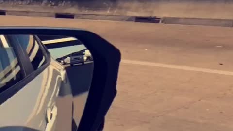 Remote Controlled Race Car Speeding Down A Busy Freeway