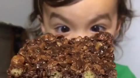 Toddler goes in hard on a chocolate peanut butter Rice Krispie treat