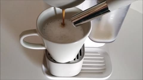 Coffee falling into the cup