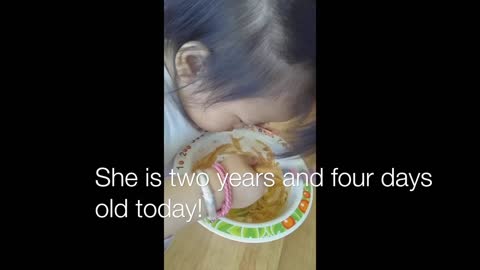 A Two Year Old Eating With Chopsticks