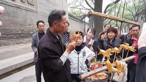 Street Vendor Blows Sugar Into Detailed Sculptures