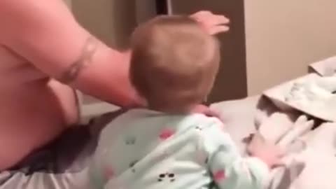 Happy baby is playing with dad and pretends to fallOVER.....