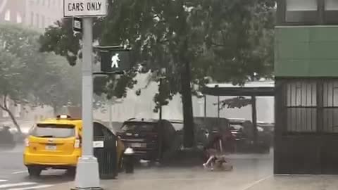 Unfortunate woman gets totally soaked during New York City downpour