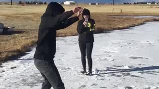 Guy black sweater slides on ice falls