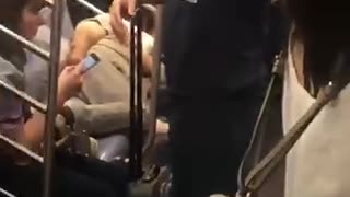 Man asleep on crowded subway train