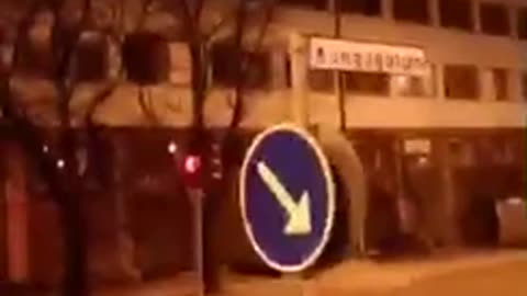 Drunk guy runs his head into blue arrow sign and falls down