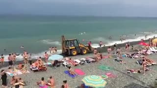 The tractor is doing the job on the beach