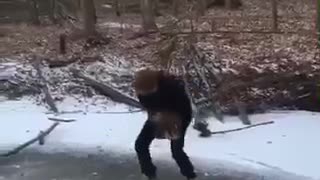 Guy drops giant rock on frozen lake falls