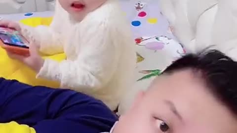 look at this very funny baby trolling his father watch