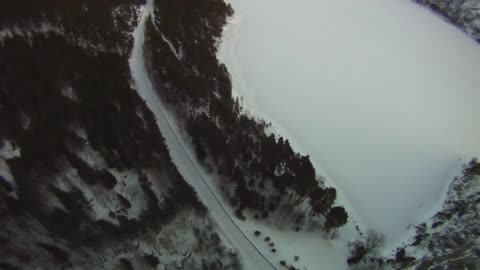 Winter BASE jump from an icy cliff