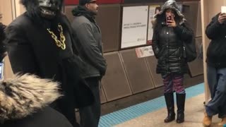 Guy dressed in gorilla tuxedo suit dances in subway station