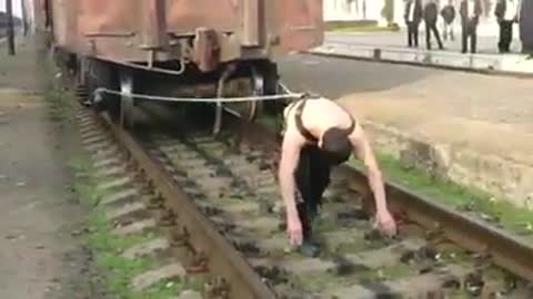 Supernatural man dragging a train with a rope