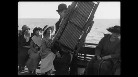 Charlie Chaplin struggles with a deck chair (_A Day's Pleasure_)