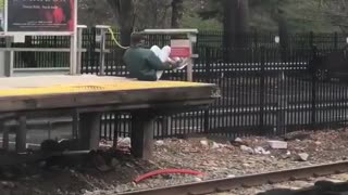Man green jacket works out on train platform
