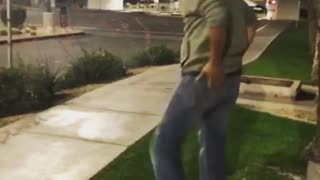 Guy tries to swing on street sign