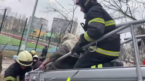 Firefighters rescue bloodied Ukrainians fleeing burning Kyiv apartment block