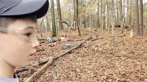 Slow motion BB gun shooting at Root Beer snipers in the woods.