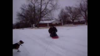 Guy Being Towed On A Sled Takes Out Neighbor's Mailbox