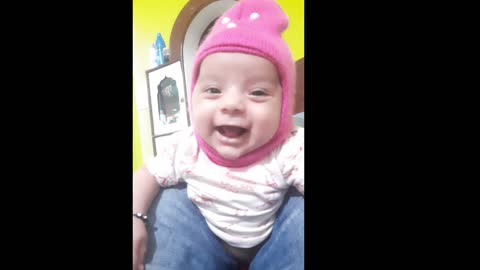 A cute three-month-old baby imitates his father's voice