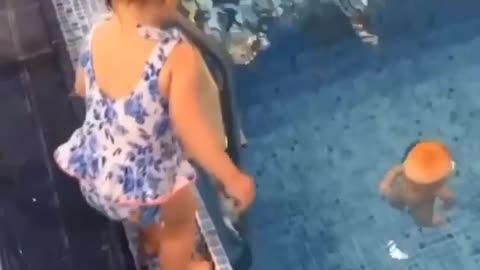 A little girl saved the doll by jumping into the swimming pool.