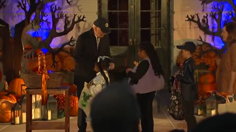 Joe Biden coughs all over his hands before handing out candy to kids