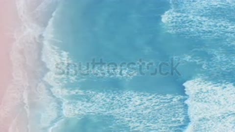 stock-footage-aerial-view-of-the-sunsets-over-sea-beautiful-sea-waves-pink-sand.mp4